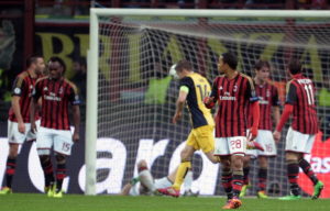 AC Milan's players react after Atletico Madrid scored during the Champions league football match AC Milan vs Atletico Madrid at the San Siro Stadium in Milan on February 19, 2014. AFP PHOTO/ Filippo MONTEFORTE (Photo credit should read FILIPPO MONTEFORTE/AFP/Getty Images)