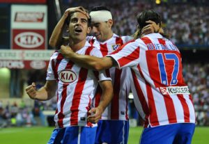 Atletico Madrid's midfielder Jose Manuel Jurado (L) celebrates with teammtes midfielder Jose Antonio Reyes (C) and Czech defender Tomas Ujfalusi after scoring against Sporting Gijon during their Spanish League football match at Vicente Calderon stadium in Madrid on August 30, 2010. AFP PHOTO / PIERRE-PHILIPPE MARCOU (Photo credit should read PIERRE-PHILIPPE MARCOU/AFP/Getty Images)
